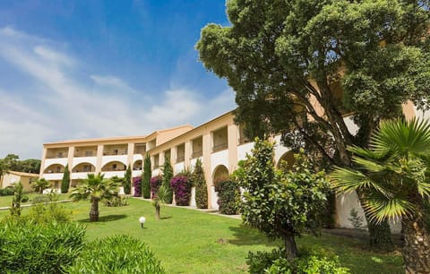 Mediterranean-style architecture nestled in lush Corsican gardens creates a relaxing, seaside ambiance.