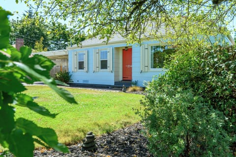 Charming and colorful exterior with large, landscaped front yard.