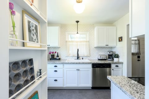 Fully equipped kitchen with dishes, glassware and pots & pans.