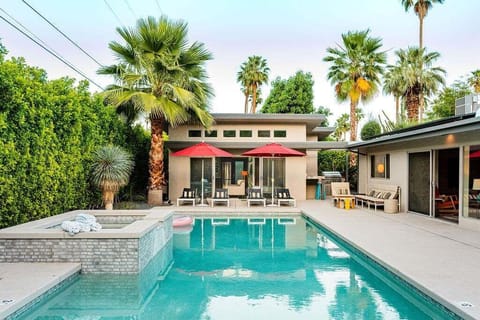Relax beside the sparkling pool and spa surrounded by lush privacy hedges and modern desert design.