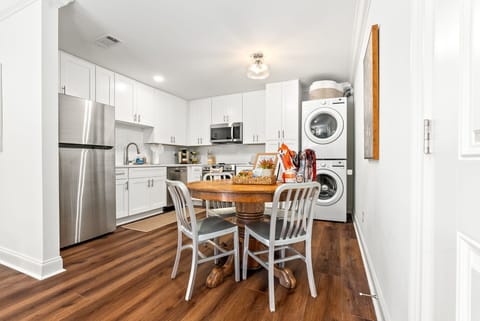Round dining table with seating for four, perfect for shared meals.