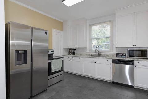 Kitchen has a stove, dishwasher, microwave, refrigerator/freezer with water dispenser