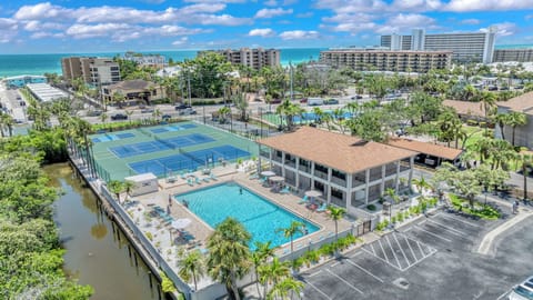 Take in the full scope of your island oasis—from the sparkling pool and lively tennis courts to the serene canal—where every corner invites you to relax, play, and explore.