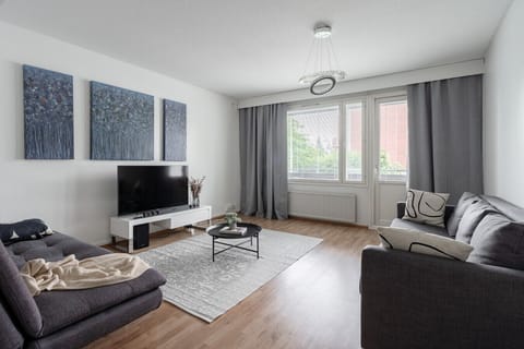 Bright, stylish living room with cozy seating, perfect for relaxing after exploring Jyväskylä.