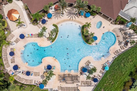 A large resort pool with surrounding lounge chairs and umbrellas for relaxing.