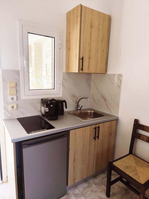 Compact Kitchenette Area
Fully equipped kitchenette with fridge, stovetop, and cooking essentials.