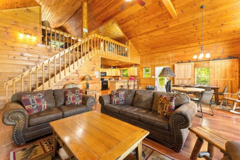 Spacious living room with a gas fireplace, full size sofa sleeper, and smart TV