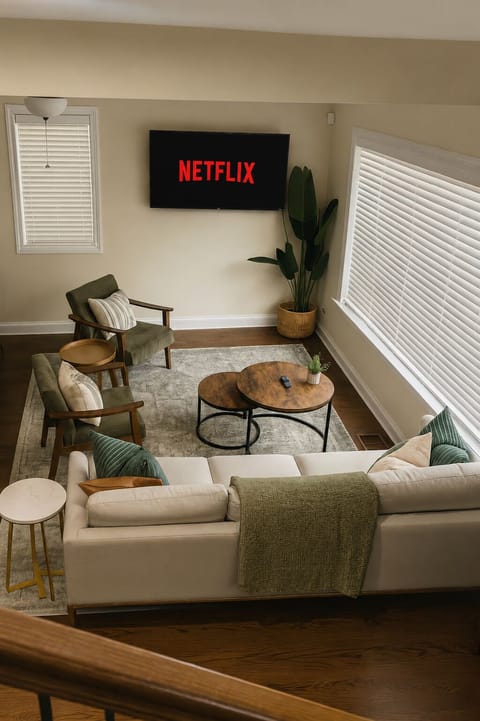 Cozy, sunlit living room with Netflix-ready TV and stylish seating