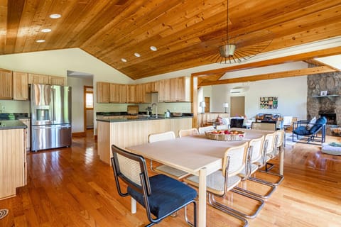 Dining table includes comfy seating and views to the living room