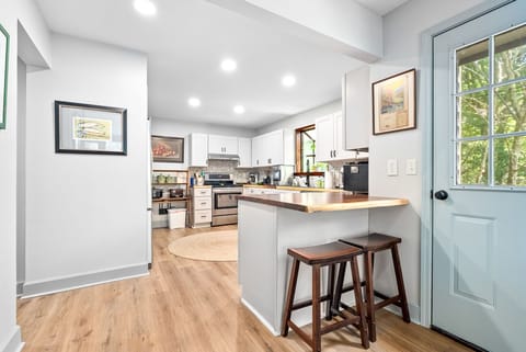 This bright and open kitchen invites conversation and connection. Pull up a stool for a quick bite, enjoy a coffee by the door, or gather with loved ones to cook and share a meal together.