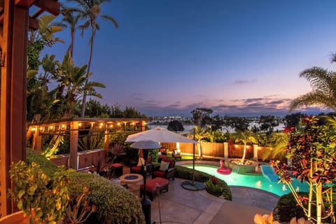 Unwind in total serenity as the pool glows at sunset, surrounded by lush tropical gardens and tranquil coastal views.