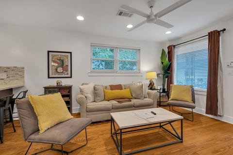 Spacious living room with plenty of comfortable seating, large TV w/ streaming services, and tons of natural light.