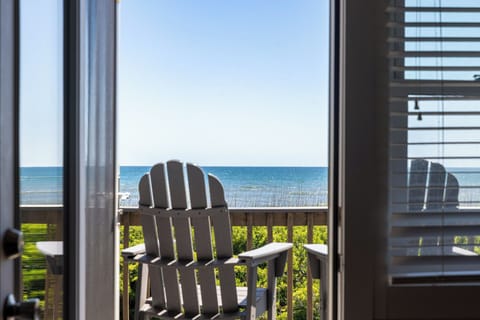 Private balcony with Adirondack chairs and beautiful ocean views