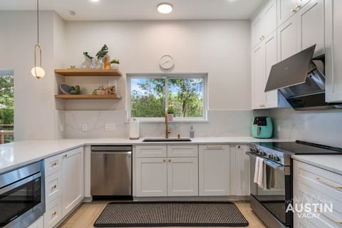 Spotlight on the kitchen. Where gold meets gadgetry and every appliance plays a starring role.