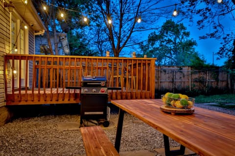 Back yard with grill, outdoor seating, and fire pit area