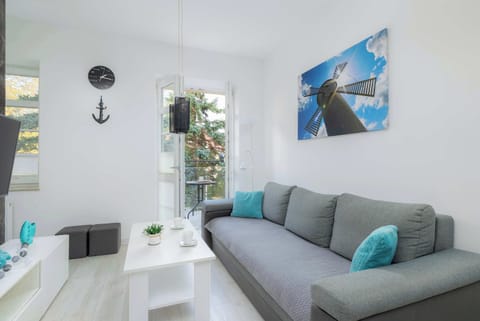 Living room with a comfortable sofa and TV. 