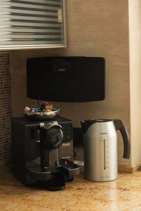 A compact coffee station featuring a modern coffee machine and a toaster. The sleek setup ensures convenience for a quick morning routine.