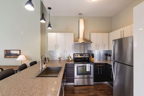 A fully-equipped kitchen featuring high-end finishes and bar seating—everything you need to prep, cook, and refuel