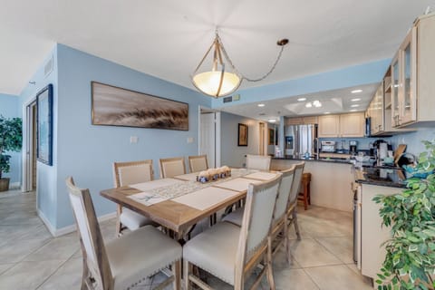 Charming kitchen and dining space with beautiful tile backsplash and ocean light.