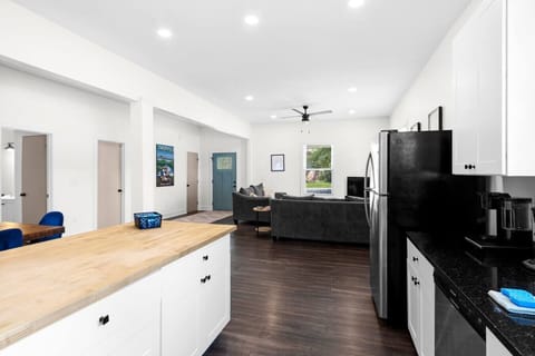 The open floor plan kitchen is fully equipped with stainless steel appliances -refrigerator, stovetop and over, coffee maker, toaster, microwave, and dishwasher — everything you need for a convenient and comfortable stay.