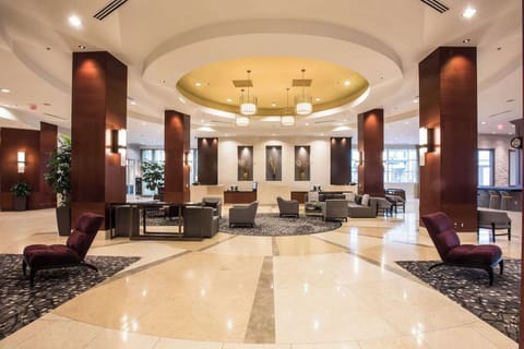 Spacious lobby with round seating area and warm lighting
