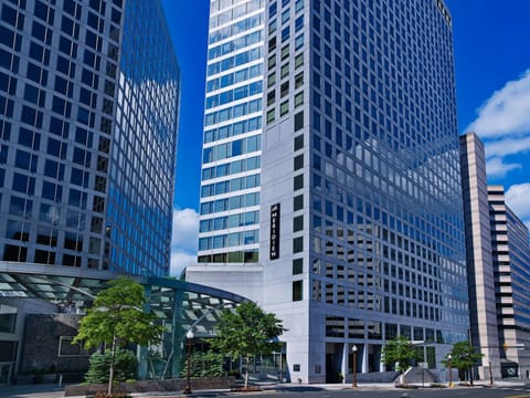Tall glass building with Le Méridien sign in a city setting