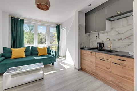 Large windows fill the room with natural light, creating a cozy atmosphere.