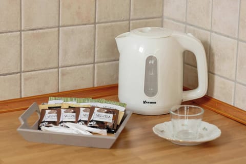 A kettle with a tea set makes mornings and evenings more comforting.