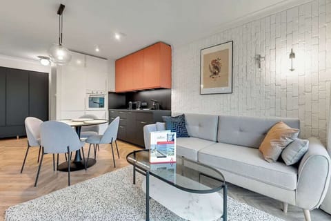 Combines chic gray tones, sleek black and coral accents, and cozy textures for a sophisticated yet inviting feel.