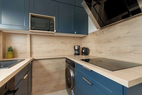 Another angle of the same kitchen with a focus on cabinetry and appliances.