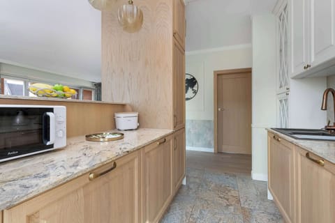 Another perspective of the kitchenette showing the dining space and the seamless transition to the living room.