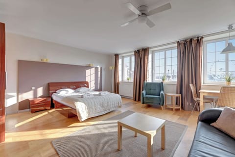 The living area features a sleek coffee table and a flat-screen television.