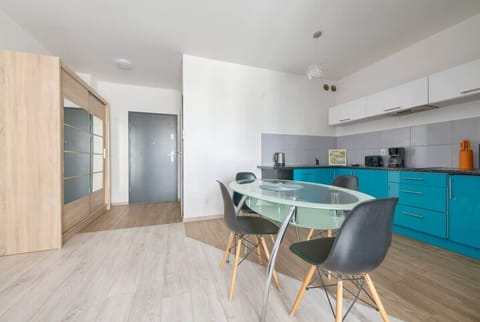 The spacious glass table with elegant chairs offers a perfect spot for shared meals.