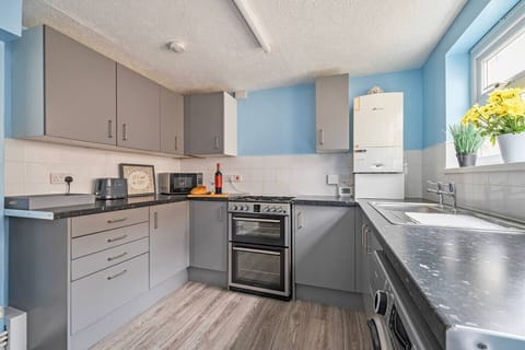 Full kitchen with oven, microwave, and ample counter space