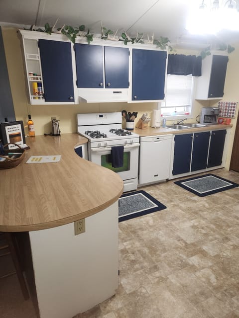 Kithcen with new painted cupboards and updated appliances. The cookstove is gas.