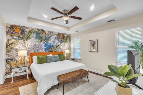 Bedroom 1 | Spacious retreat with king bed, bold accent wall, and modern decor.