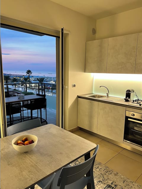 Kitchen and dining opening to the balcony with the sea view
