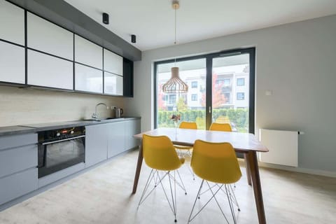 A fully equipped kitchen with modern appliances, seamlessly integrated with a cozy dining area.
