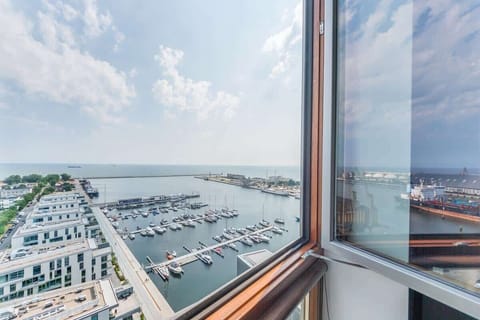 Panoramic views of the city and the sea, visible from the large living room windows.