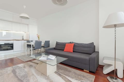 Relax in the stylish living room with a comfortable sofa and modern decor.