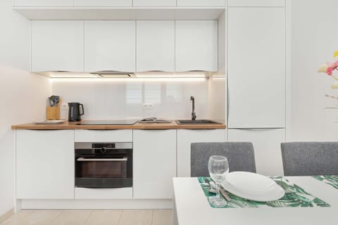 The sleek design of the kitchenette blending seamlessly with the living area.