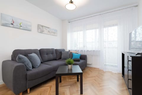 A bright living room with a comfortable sofa and large window invites you to unwind after a day of exploring.