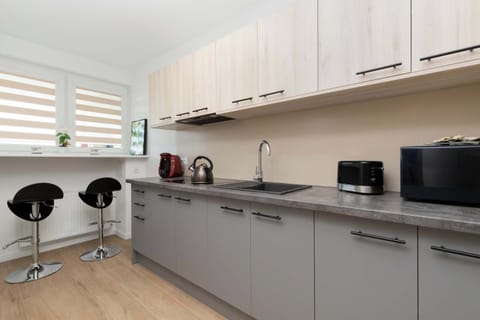 The spacious kitchen with a breakfast island and modern appliances is perfect for cooking together.