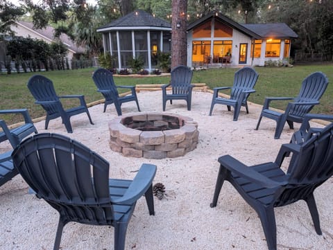 Enjoy the open skies and warm fire with 10 seats at the backyard fire pit!