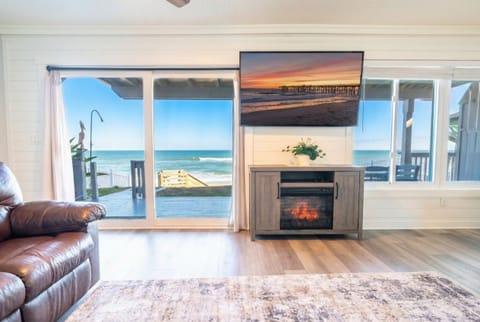 Direct oceanfront living at Vista Mare with unobstructed Atlantic views and steps to Flagler Beach's historic coquina sand. Cozy fireplace and sunset views from your sofa. Your beachfront escape awaits.