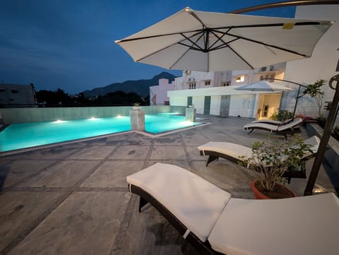 Outdoor pool, open 7:00 AM to 6:30 PM, pool umbrellas, sun loungers
