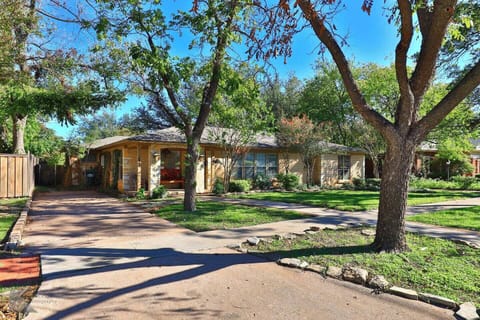 Inviting exterior of the Sayles Ranch Guesthouse with sidewalks for evening strolls through the historic neighborhood