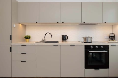 The built-in kitchen with an oven and stovetop makes cooking your favorite meals easy.

