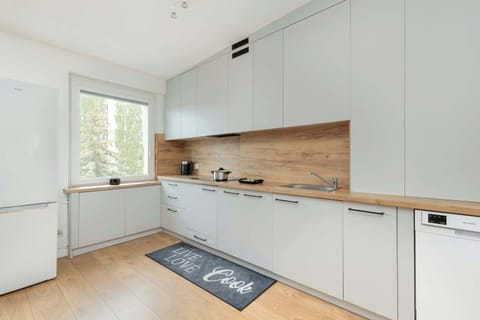 he elegant kitchenette with modern appliances and spacious white cabinets ensures convenience and style while preparing meals.