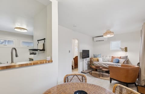 View from dining area into Kitchen/Living room. Far doorway goes into bedroom.